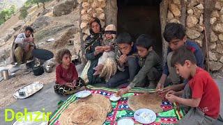 The father of the nomadic family cooking local bread for his children in the mountains