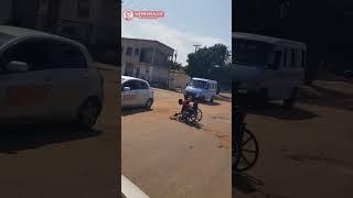 DISABLED MAN FILLING A POTHOLE