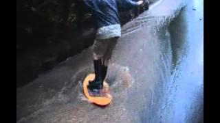 Kid Falls Trying to Skimboard Flooded Street
