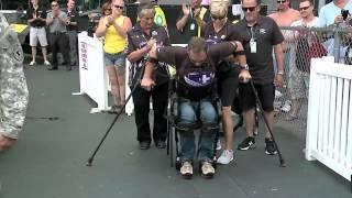 U.S. Army Pilot Gary Linfoot stands for National Anthem with Exoskeleton