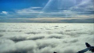 Airplane flying into clouds - pilot cockpit view