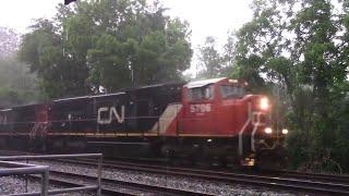 3 CN's pull K676 past St.Denis in a downpour