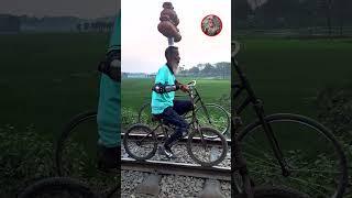 Amazing Talent- Riding motorbike and bicycle on rail line with 9 clay pot on  head!