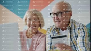 Happy elderly couple making payment online with credit card enjoying shopping