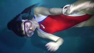 girl underwater rolling free in 5 meters deepth pool with one breath