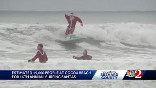 Surfing Santas hit waves at Cocoa Beach on Christmas Eve for 16th year