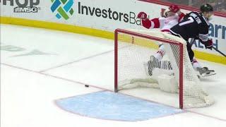 Dougie Hamilton hits Tyler Bertuzzi as he tries to shoot the puck into the empty net