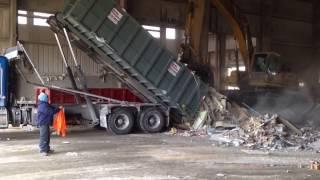 Frozen Dumpster getting scraped out with an excavator when it will not dump on its own