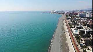 aerial view of adler sochi beach town and mountains waterfront