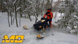 Off-Trail Snowmobile Riding Up Hill in Tight Trees