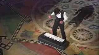 Entertainer Plays Keyboard with Tennis Balls