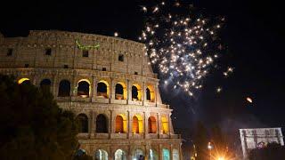 Happy New Year! Fireworks explode in the sky over Rome's Colosseum