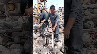 Cleaning buoys with a machine: men cleaning buoys with a machine