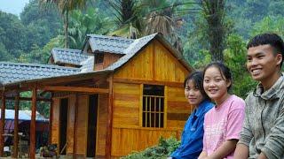 Finishing the wooden wall: Pao spray paints his small house