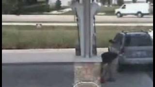 Guys car rolls away from him at the gas station