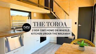 Ruru Tiny Homes: The Toroa - double storey two bedroom tiny home on wheels - Kitchen under walkway