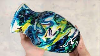 Colorful alcohol ink and epoxy resin on a white vase on a cup turner - greens and blues