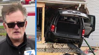 Neighbor reacts after car crashes into home