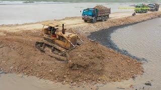 Dump Trucks unloading dirt & Bulldozers pushing dirt