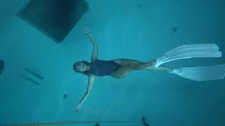 girl underwater rolling free in 5 meters deepth pool with one breath