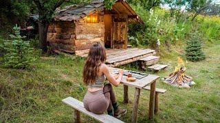 A beautiful girl lives in a log cabin.  Cooks pancakes and draws