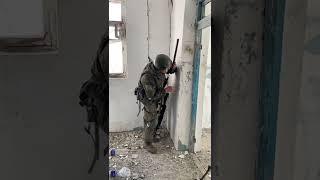 A Russian soldier uses hand-held periscope at the Azovstal plant in Mariupol, Ukraine