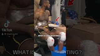 LeBron James eating in the locker room next to Anthony Davis minutes after winning the NBA Cup