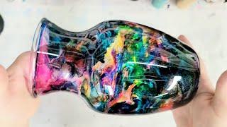 Colorful rainbow alcohol ink and epoxy resin on a vase on a cup turner