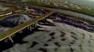 Isolated bridge on a frozen lake - Aerial Video (Podul si ecluza de la Budesti)
