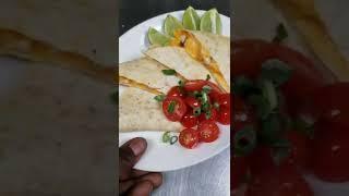 chicken quesadilla.   tomatoe garnish.  limes