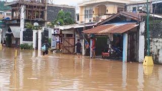 Residents begin clearing streets after storm triggers floods in Philippines