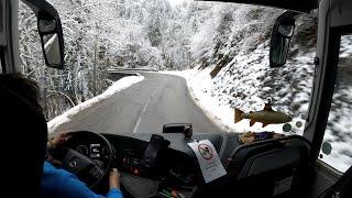 Early bus drive to snowy mountain in the Alps