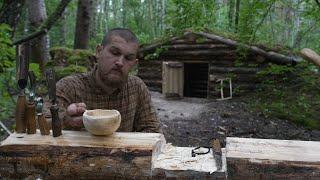woodworking in dugout at heavy rain , making kuksa , no talking