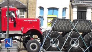 A PAIR OF MONSTER TRUCKS RED ONE BIG PETE AND THE OTHER IS GRIM REAPER