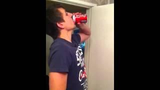 Downing a can of coke
