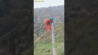 Aerial Electrical Work: Female Lineworker on Utility Pole