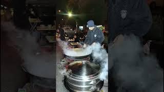 Where Steam Meets Sizzle: A Popular Street Food Stall with a Crowd