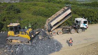 Finalizing Road Construction Power Dozer Pushing Gravel Rock with Heavy Dump Truck Spreading Extreme