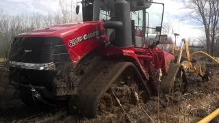 Case IH 620 quad Trac in mud pulling tile plow