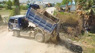 Dump Trucks Process filling land Next to the road And Dozer MITSUBISHI Experts push the soil.