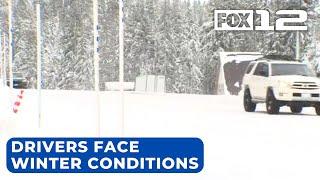 Drivers chain up to travel Cascades passes amid snowstorm warning