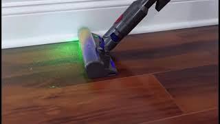 Dyson V. 15 smart vaccum picking up dust green laser