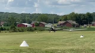 Tow plane taking off with a glider on an all grass runway