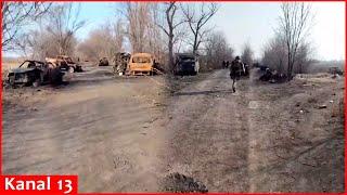 Russians show burnt-out cars, military equipment, and trucks lying on the road side