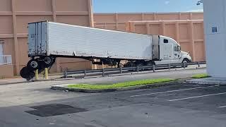 Semi-Truck Loses Back Wheels Trying to Turn Around Safety Barriers