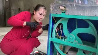 Girl repairs a powerful two-phase electric motor used for a sugar cane juice machine