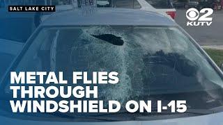 Dash cam video shows moment piece of metal went through the windshield of car on I-15