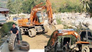 rescue tire repair excavator dx140 at high mountain construction site