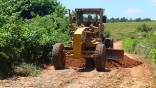 Knocking down a big pile of dirt with grader