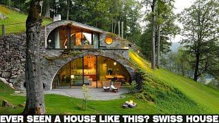 "Can you spot it? A stone house camouflaged on a hillside covered with grass and trees | Swiss house